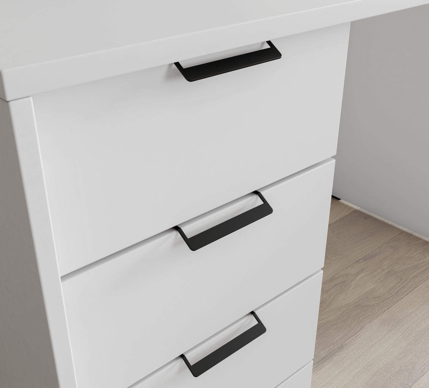 Zbliżenie na czarne uchwyty szuflad białego biurka – nowoczesny, minimalistyczny design.