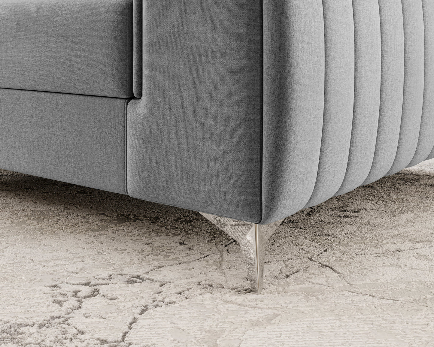 Metalowa noga fotela Laurence Nube 03 jasnoszary – detal nowoczesnego wykończenia na tle jasnego dywanu.
