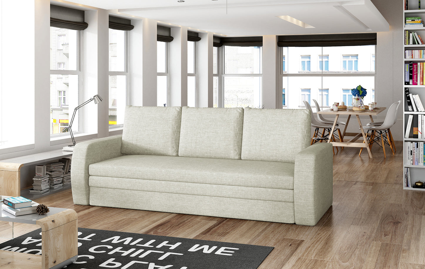 Sofa Inversa w odcieniu Cover 02 jasnoszary ustawiona w nowoczesnym, jasnym salonie z jadalnią w tle.