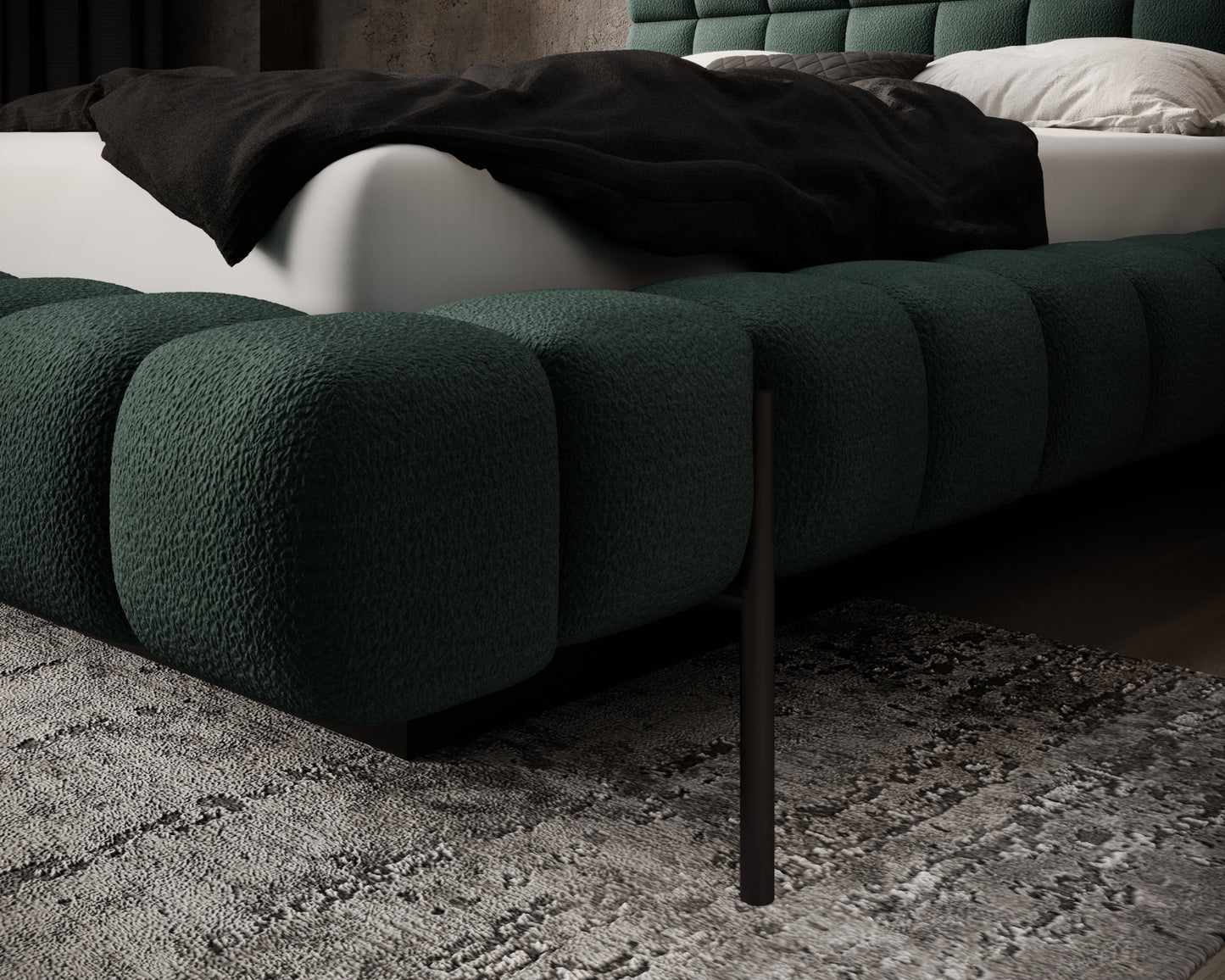 Ciemnozielony tapicerowany bok łóżka Magentta z miękkimi przeszyciami i metalową nogą, ustawiony na dekoracyjnym dywanie w sypialni.