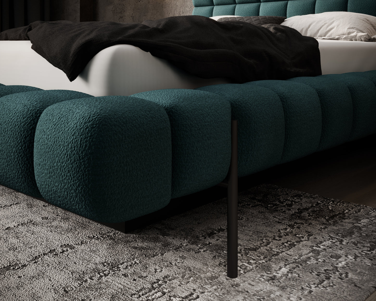 Detal narożnika tapicerowanego łóżka Magentta w tkaninie Amore 38 z widoczną czarną, metalową nóżką na tle dywanu.