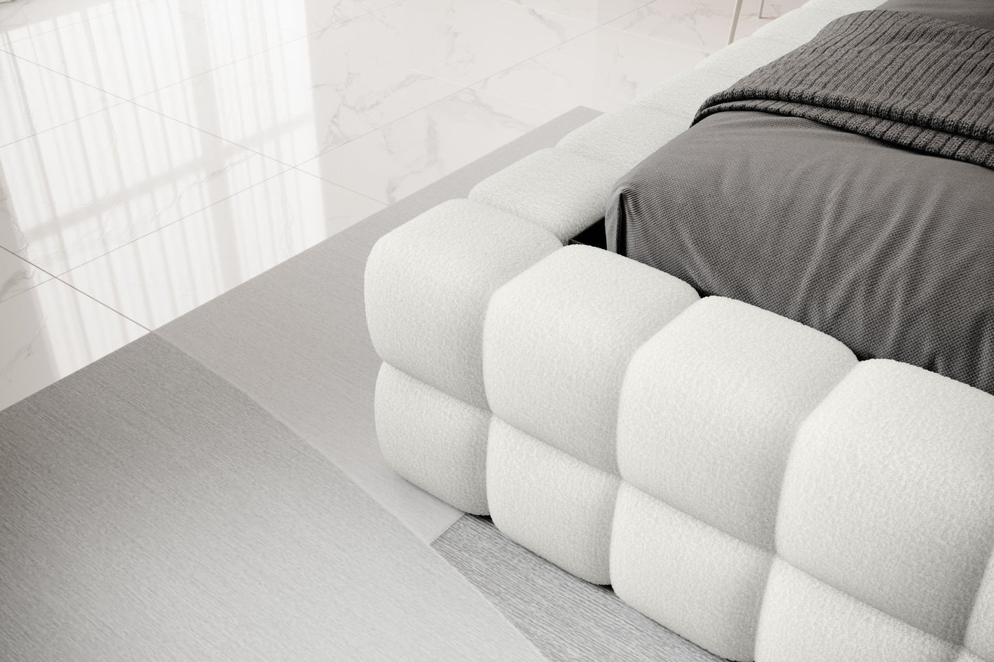 Detal narożnika łóżka Dizzle 180x200 cm w tkaninie Royal 01 biały, ukazujący miękkie, tapicerowane wykończenie w stylowym, minimalistycznym wnętrzu.