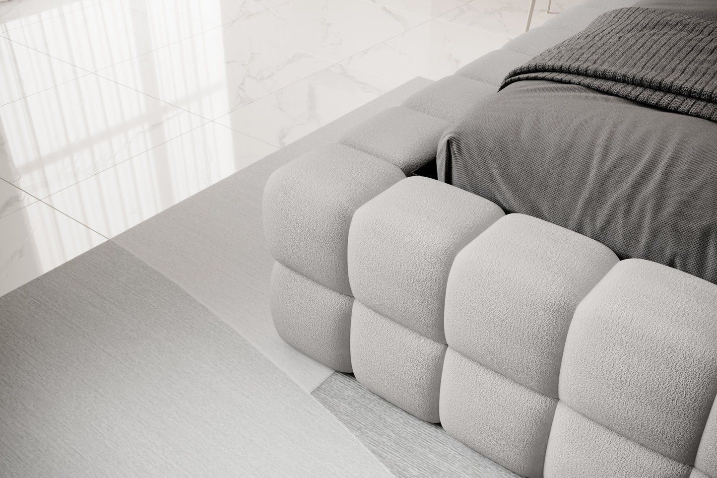 Detal narożnika łóżka Dizzle 180x200 cm w tkaninie Touch 03 jasnoszary, ukazujący miękkie, tapicerowane wykończenie w stylowym, minimalistycznym wnętrzu.