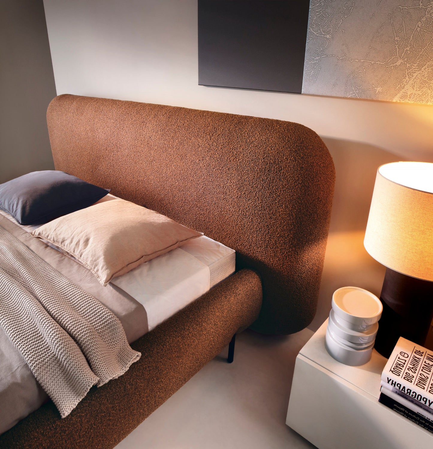 Zbliżenie na zaokrąglony zagłówek łóżka Pointt Jaffray 30 w kolorze ceglastym, obity miękką tkaniną boucle – stylowa sypialnia