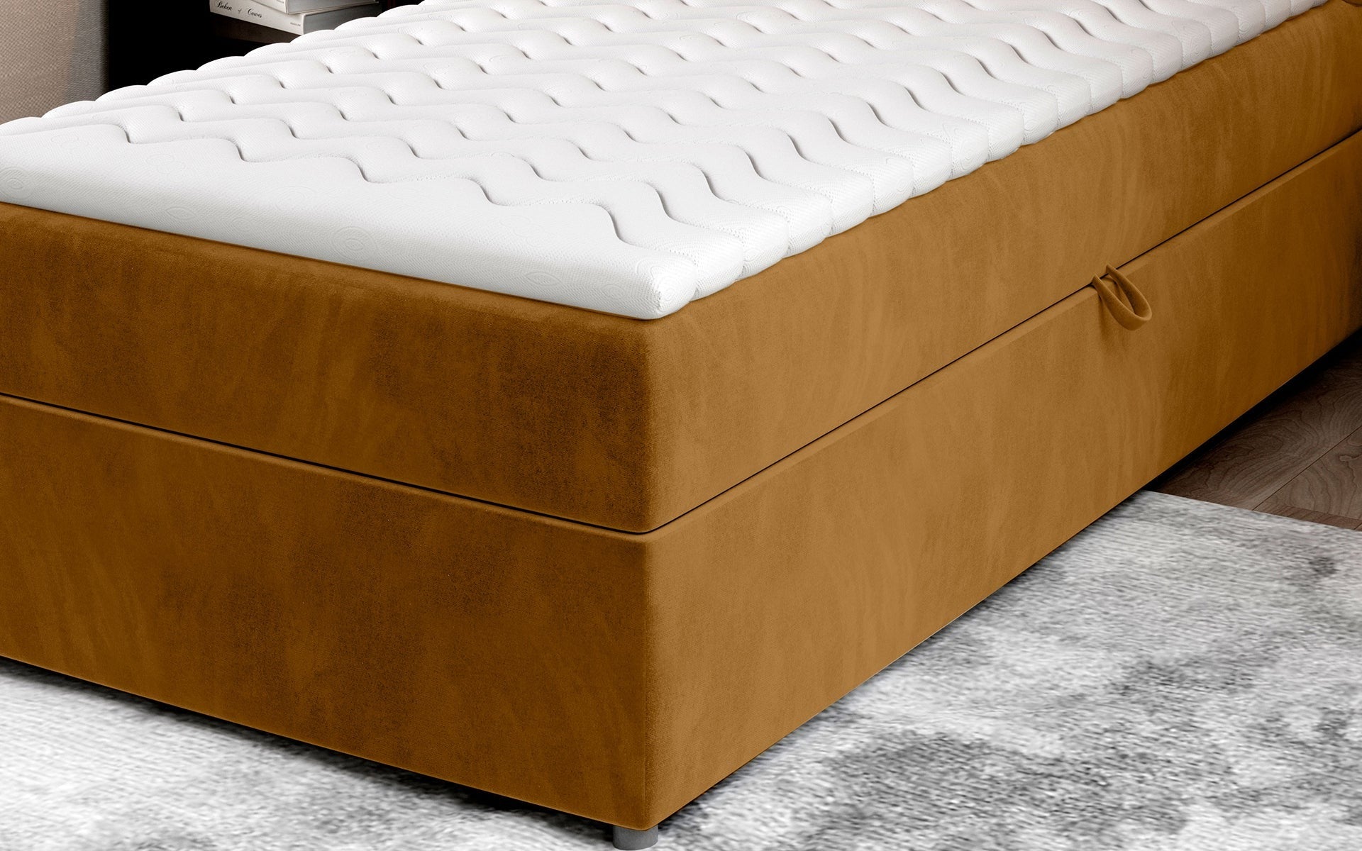 Zbliżenie na dolną część łóżka Rivia w kolorze Monolith 48 żółty o wymiarach 90x200 cm, z widocznym pojemnikiem na pościel.