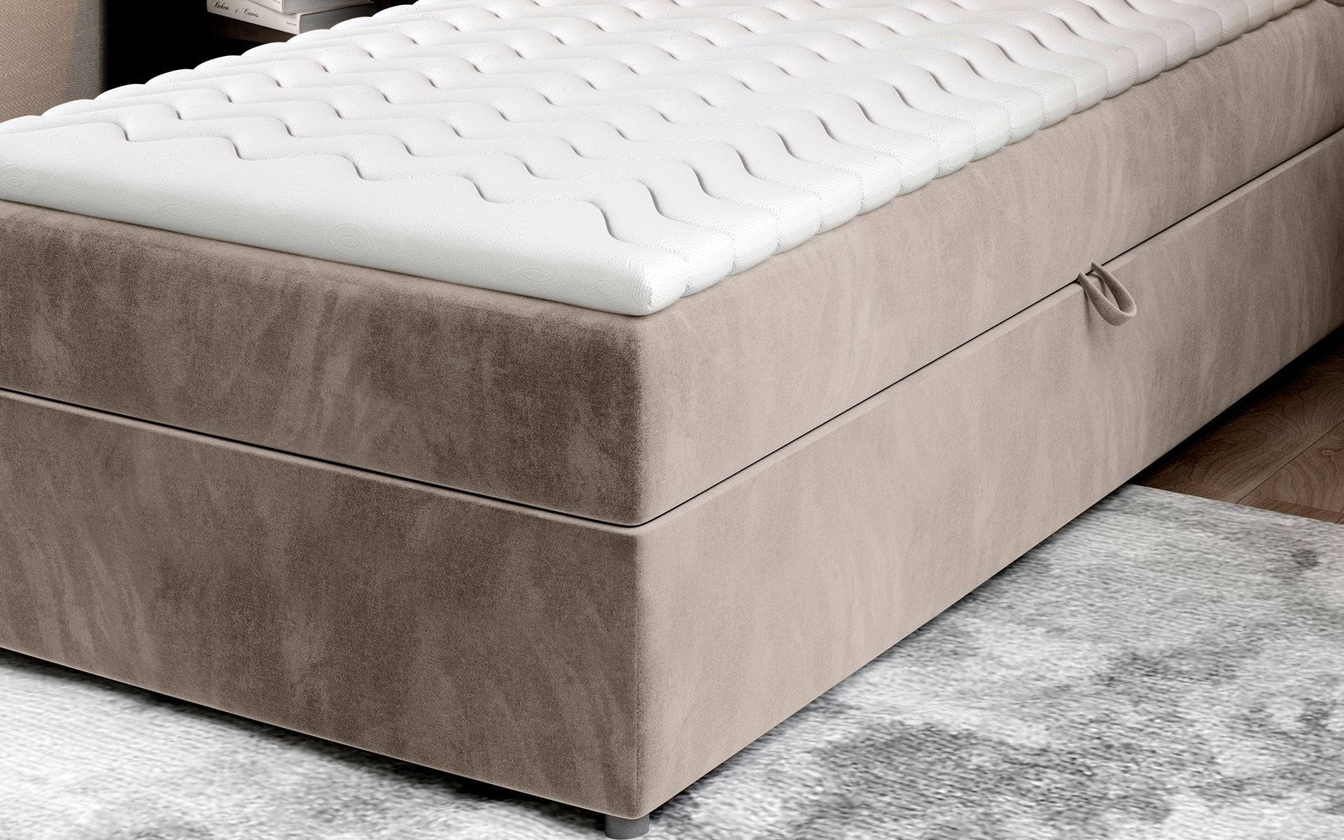 Zbliżenie na dolną część łóżka Rivia w kolorze Paros 02 beżowy o wymiarach 90x200 cm, z widocznym pojemnikiem na pościel.