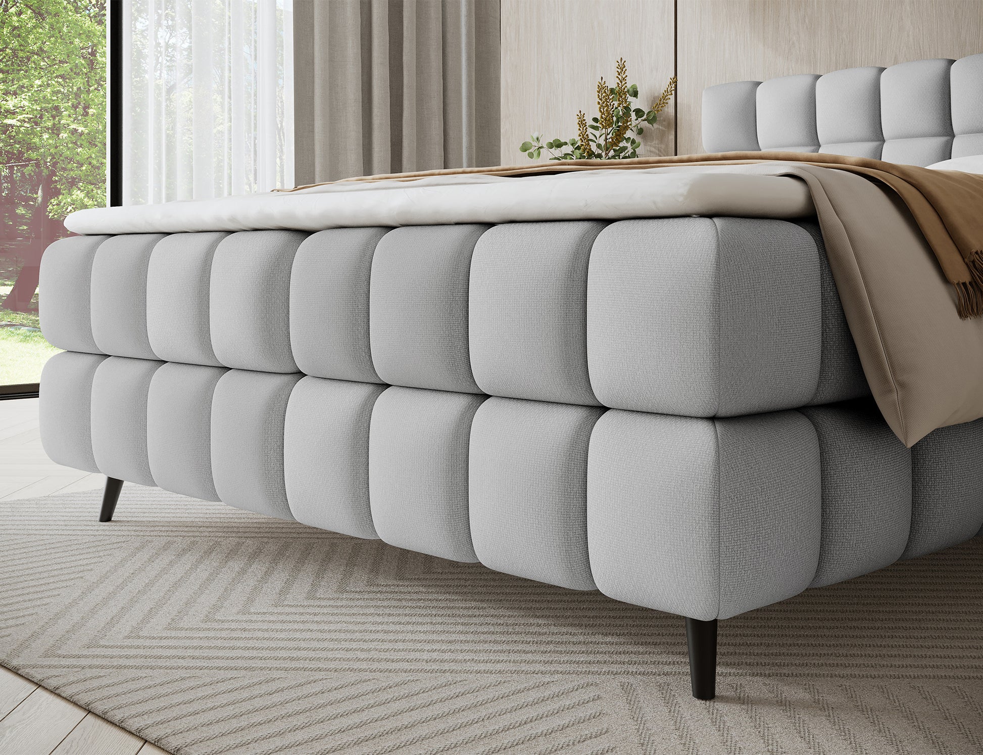 Korpus łóżka Sabeno Tonall 03 jasnoszary – miękka tkanina boucle, solidne wykonanie i drewniane nogi tworzą harmonijną, elegancką całość.