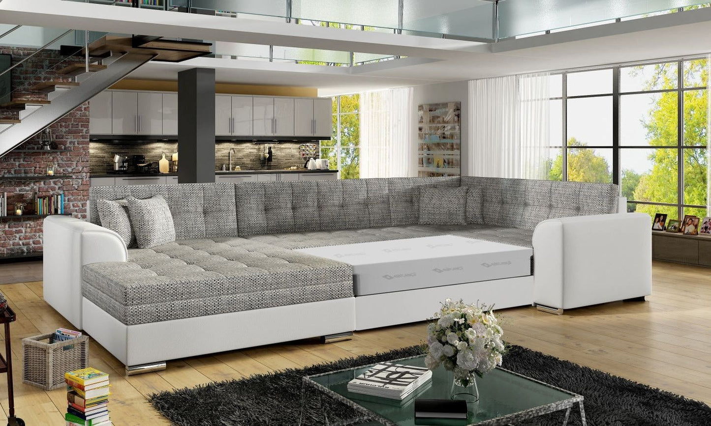 Narożnik Damario w kolorze szarym i białym z rozłożoną funkcją spania, prezentacja przestronnej powierzchni do komfortowego wypoczynku.