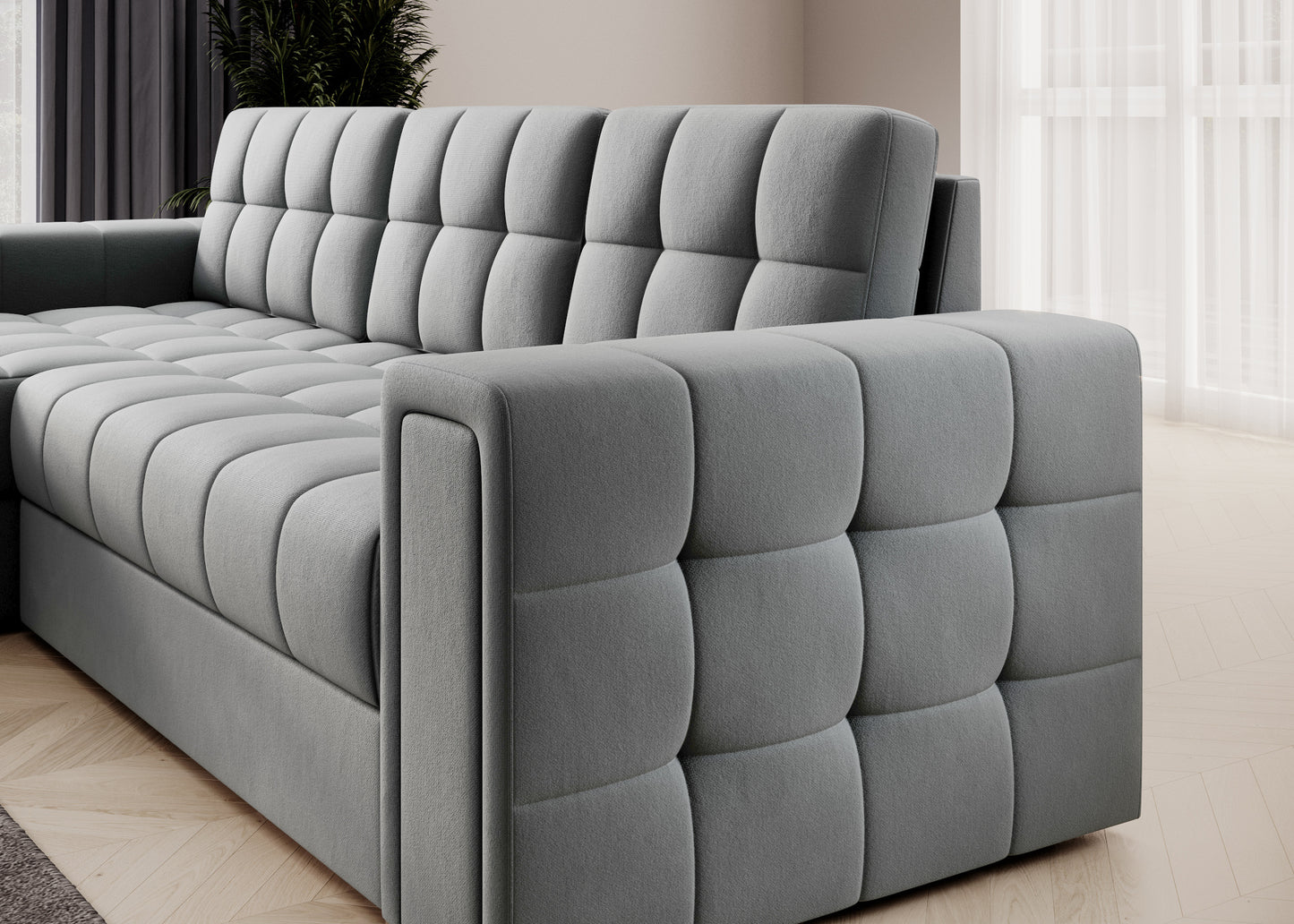 Szara sofa narożna z pikowanym bokiem i siedziskiem, nowoczesna tapicerka i elegancka forma do stylowego wnętrza salonu.