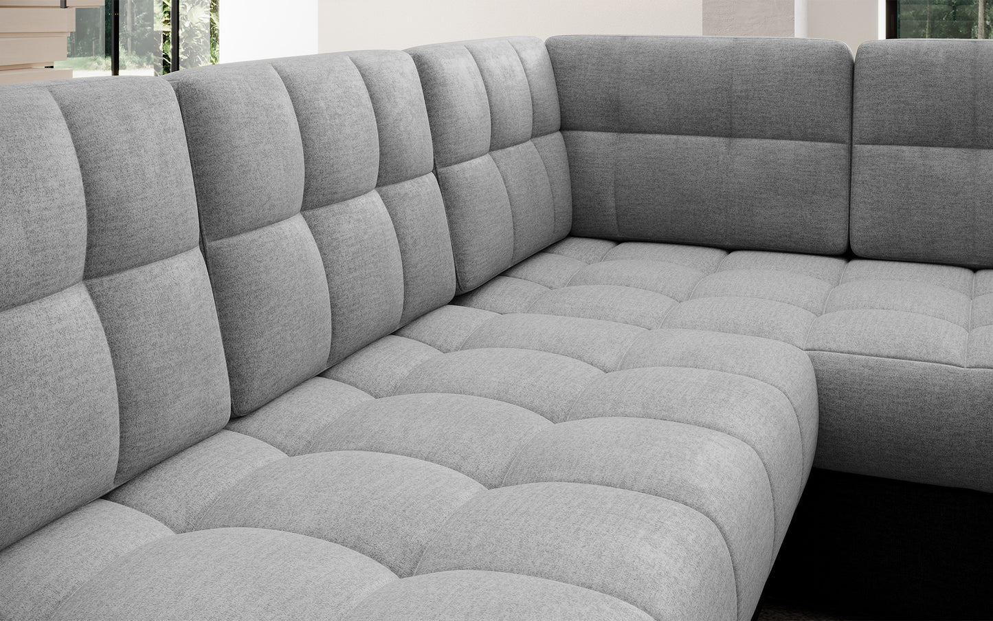 Pikowane siedzisko narożnika Blewett w jasnoszarym kolorze. Komfortowa, miękka powierzchnia wypoczynkowa o eleganckim i nowoczesnym wyglądzie.