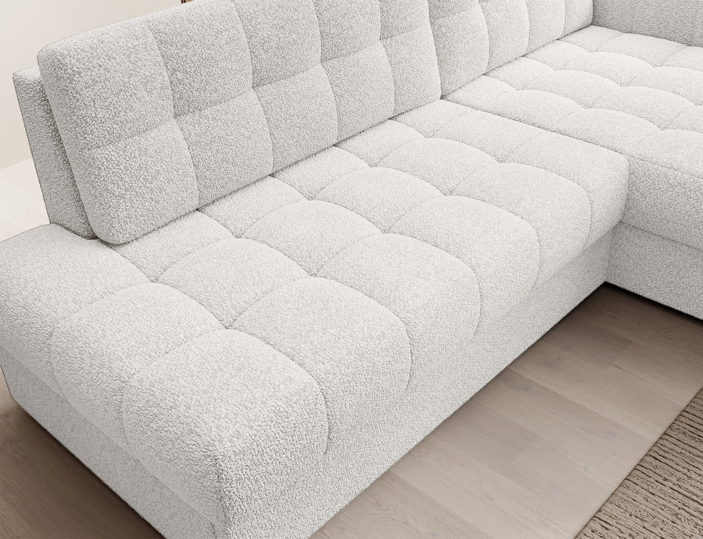 Perspektywa z góry na siedzisko narożnika Blezalt prawy Royal 01 w białej tkaninie bouclé z wyraźnym pikowaniem i podziałami modułów.