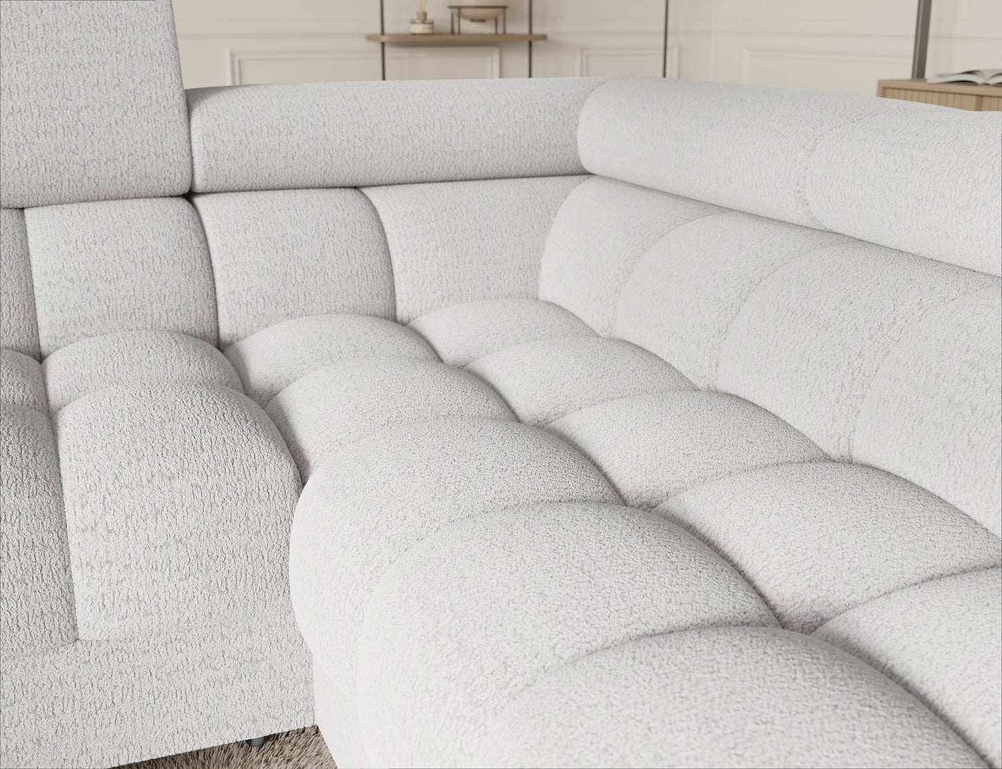 Detal narożnika Fectory w białym kolorze, z widokiem na starannie wykończone siedzisko, podłokietnik i eleganckie nogi.