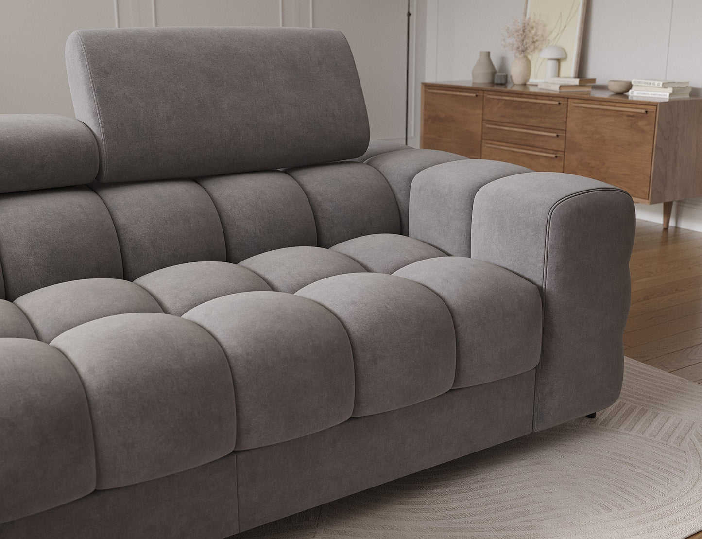 Zbliżenie na elegancki podłokietnik i regulowany zagłówek, podkreślające wysoką jakość wykonania oraz ergonomiczny design narożnika.
