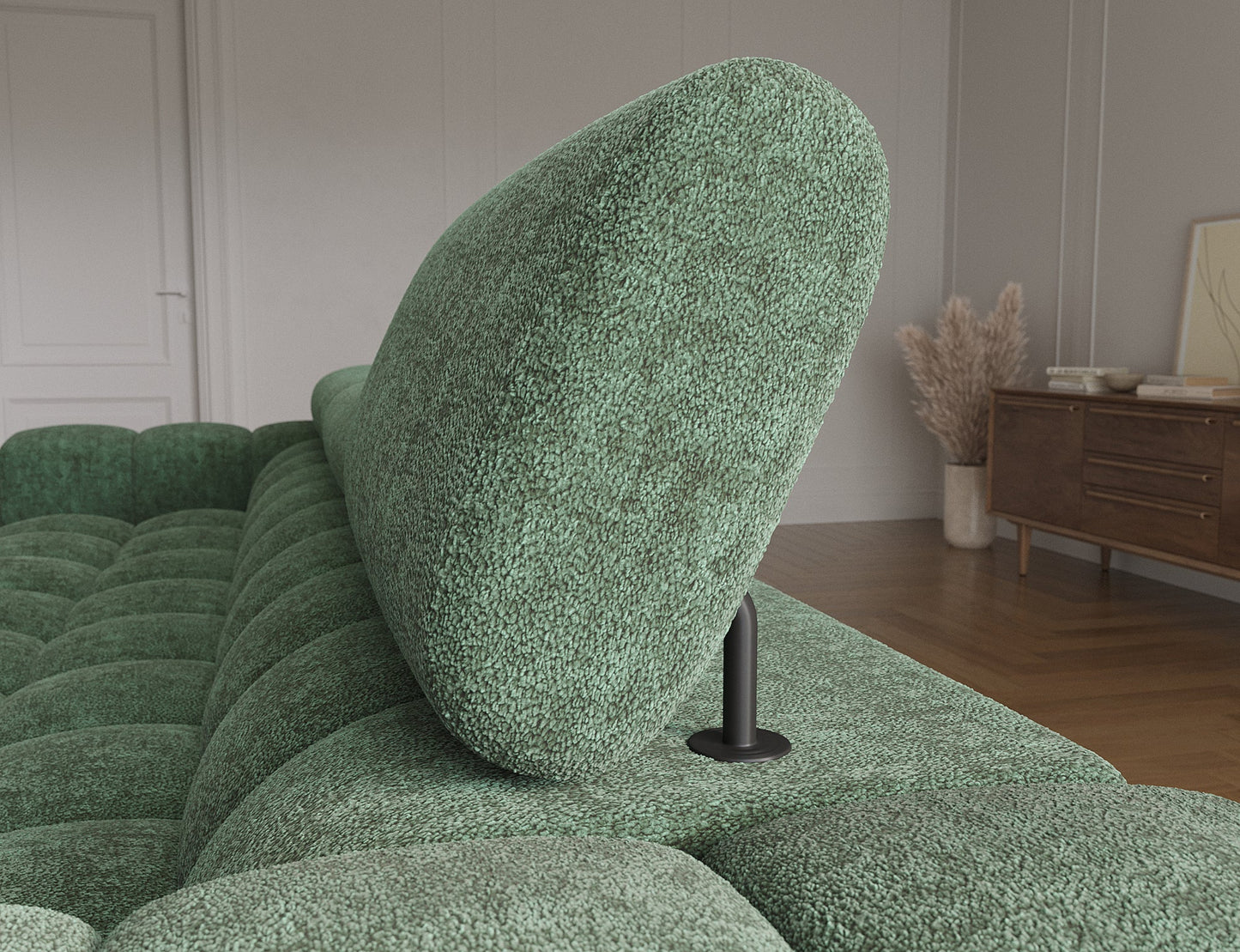 Zbliżenie na regulowany zagłówek sofy, ukazujące jego ergonomiczny kształt i solidne mocowanie dla większego komfortu.