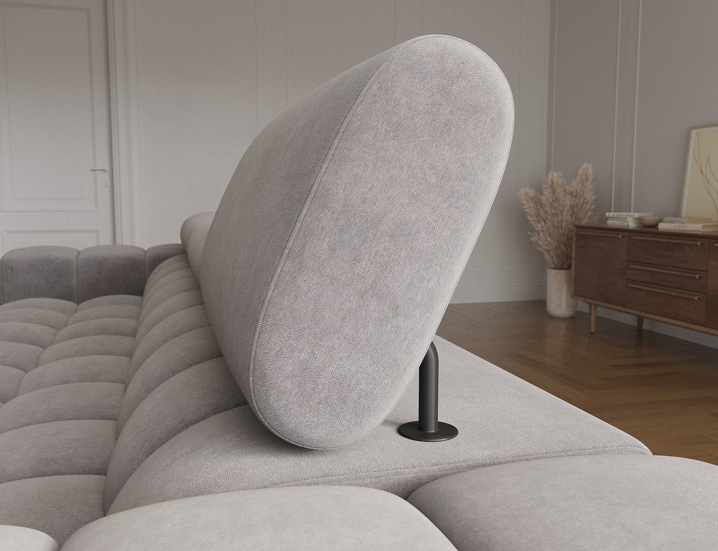 Regulowany zagłówek narożnika Felro w pozycji podniesionej – ergonomiczne wsparcie dla głowy i karku, podkreślające komfort użytkowania.