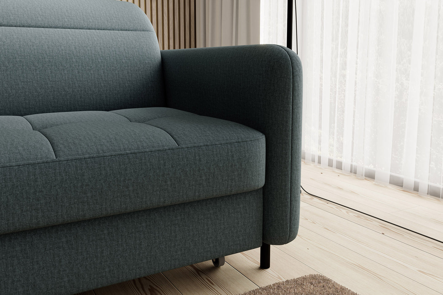 Detal prawego podłokietnika i nóżki narożnika Gomsi Manhattan 38 zielony, układ lewy – zbliżenie na prawy podłokietnik, widoczne kółko podporowe szezlongi i metalową nogę.