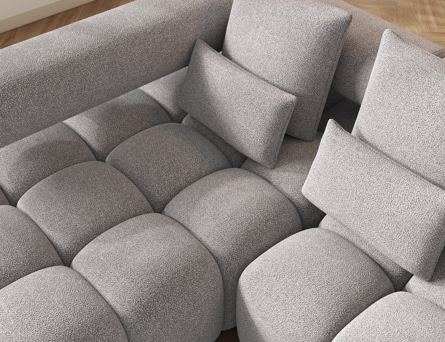 Nowoczesny detal narożnika Levvi lewy Paolli 04 szary – precyzyjne szycie i obłe kształty siedziska w tkaninie boucle.