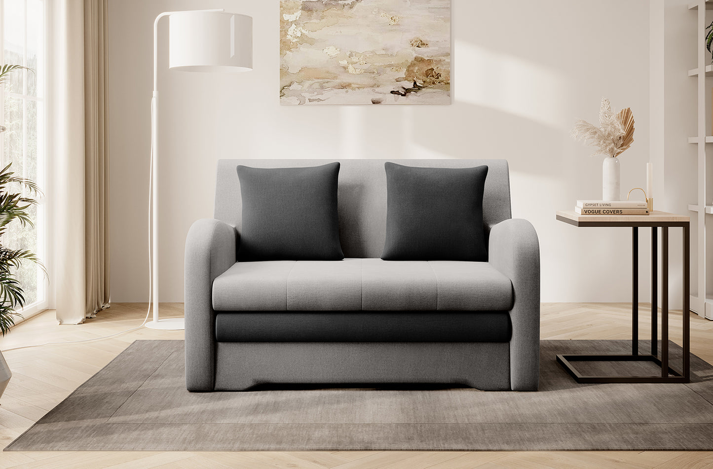 Dwukolorowa sofa Ario (jasnoszara + grafit), front; aranżacja salonu z lampą i stolikiem.