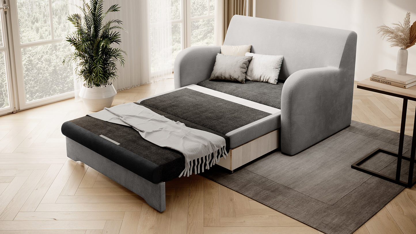 Sofa Ario dwukolorowa rozłożona do spania, ujęcie skośne w salonie przy oknie.