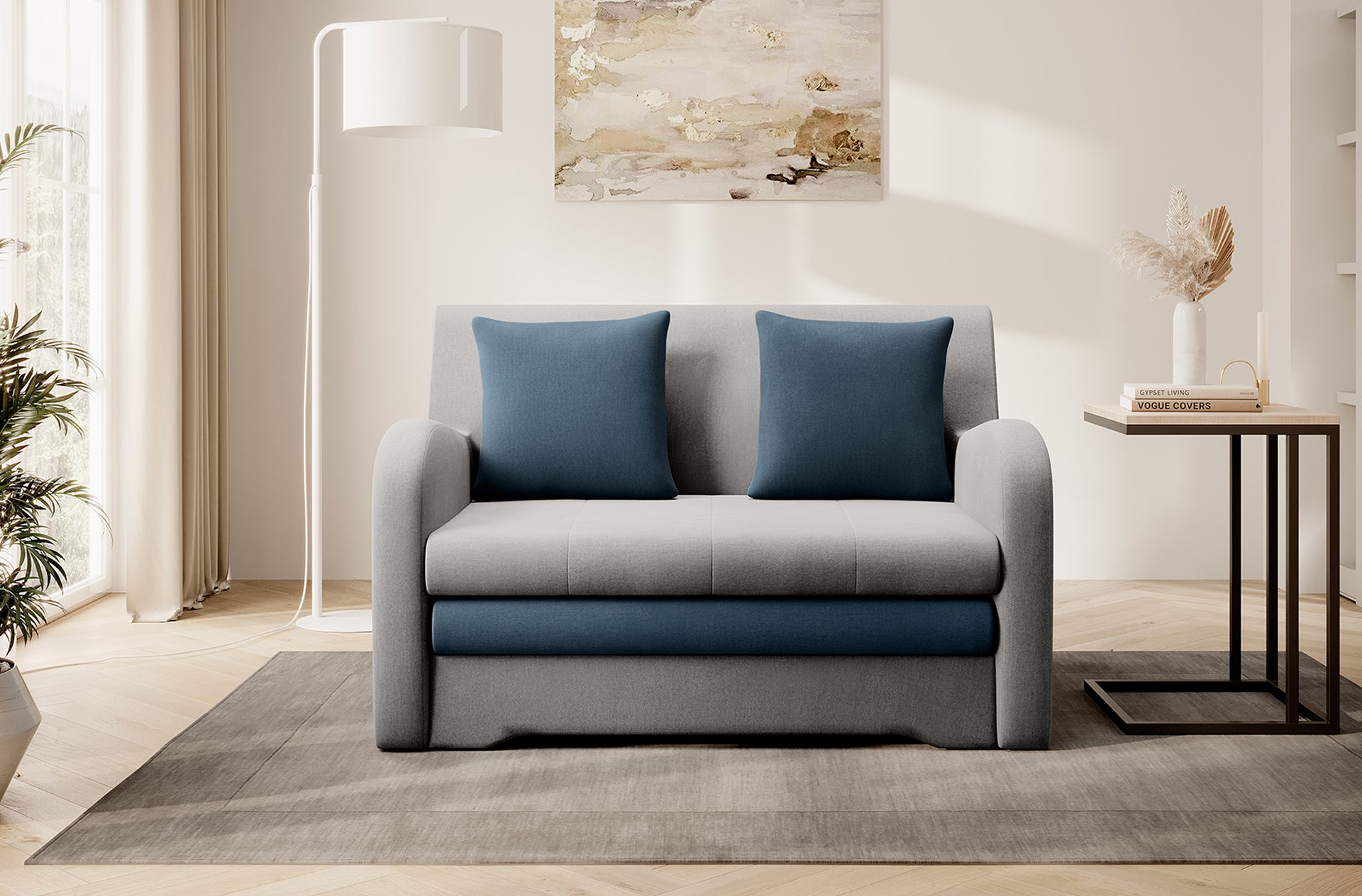 Dwukolorowa sofa Ario (jasnoszara + stalowoniebieska), front; aranżacja salonu z lampą i stolikiem.