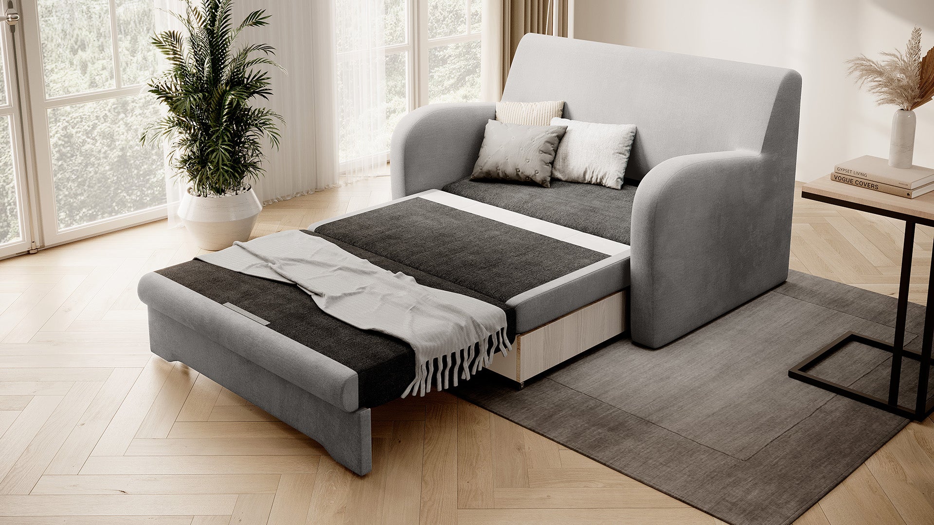 Szara sofa Ario rozłożona do spania, ujęcie skośne w salonie przy oknie.