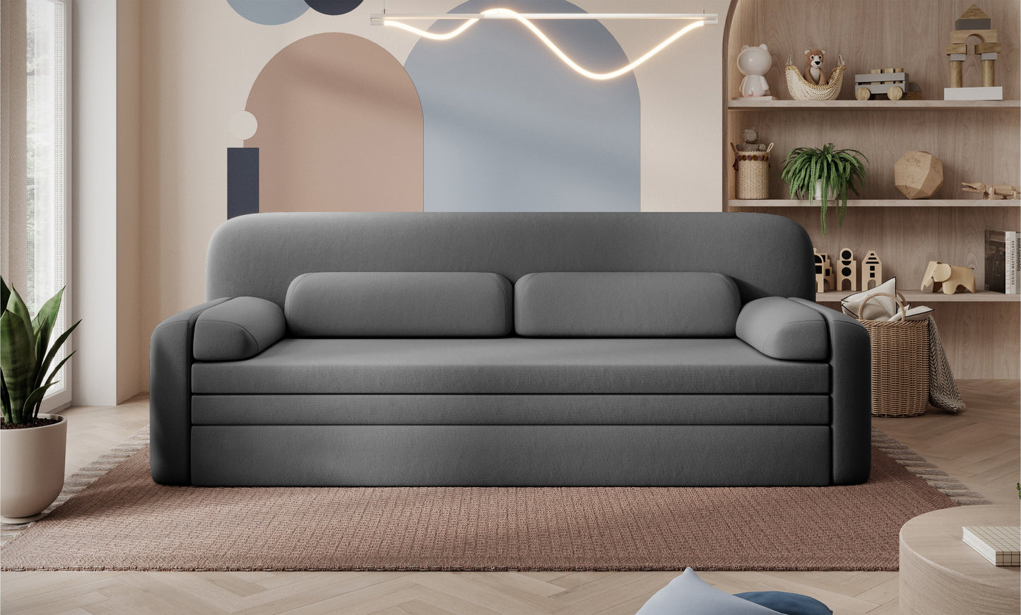 Sofa Elioss Sola 06 w kolorze szarym na tle dekoracyjnej ściany – nowoczesna forma, gładka tapicerka, jasne i przytulne wnętrze.