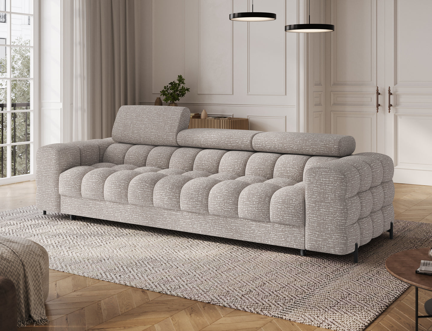 Sofa Festello Baffix 03 jasnoszary widok pod skosem, elegancki mebel z funkcją spania i dekoracyjnym pikowaniem.