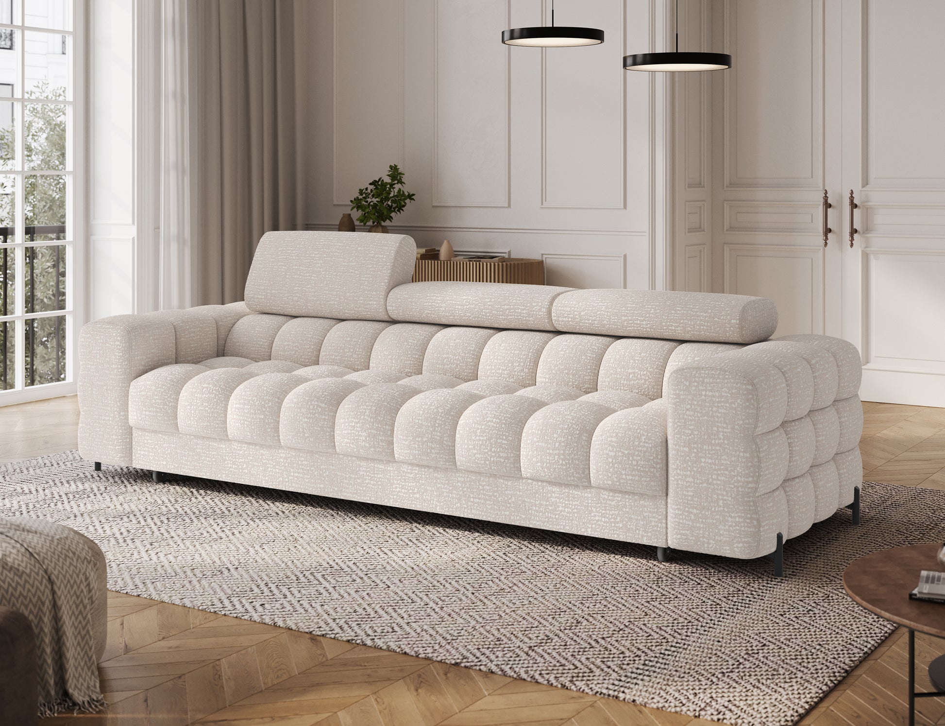 Sofa Festello Baffix 20 w beżowym kolorze widziana pod skosem, elegancka forma z pikowanymi detalami.