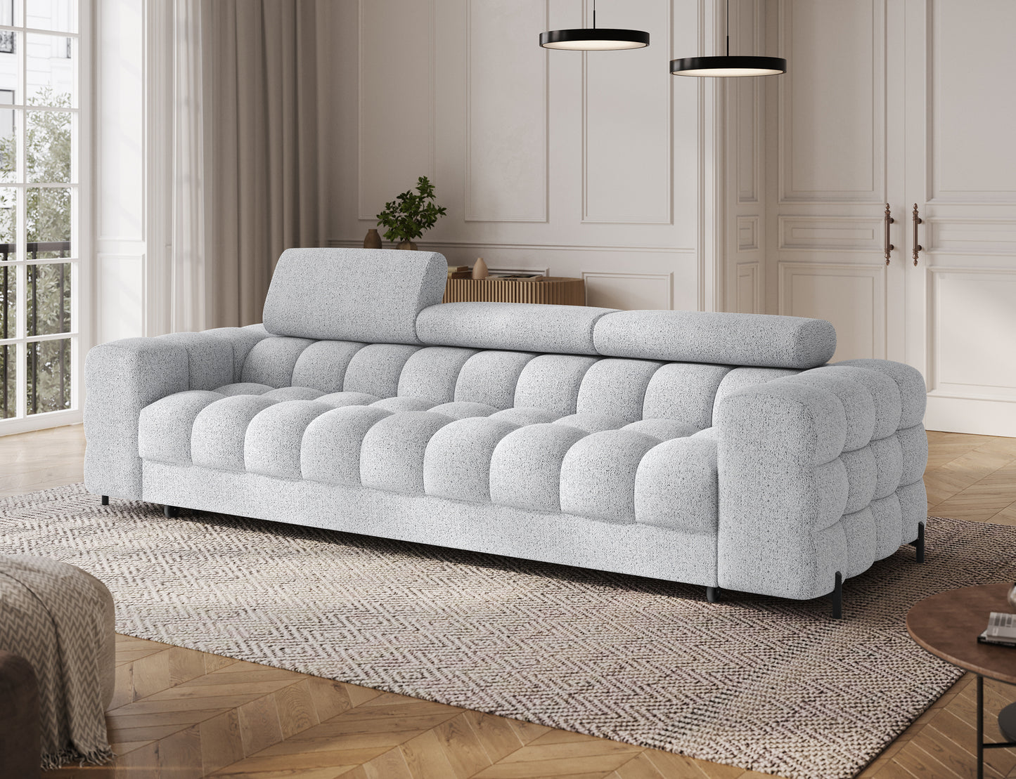 Sofa Festello Coralline 01 biała – widok z boku ukazujący eleganckie linie, regulowane zagłówki i nowoczesny design do salonu.
