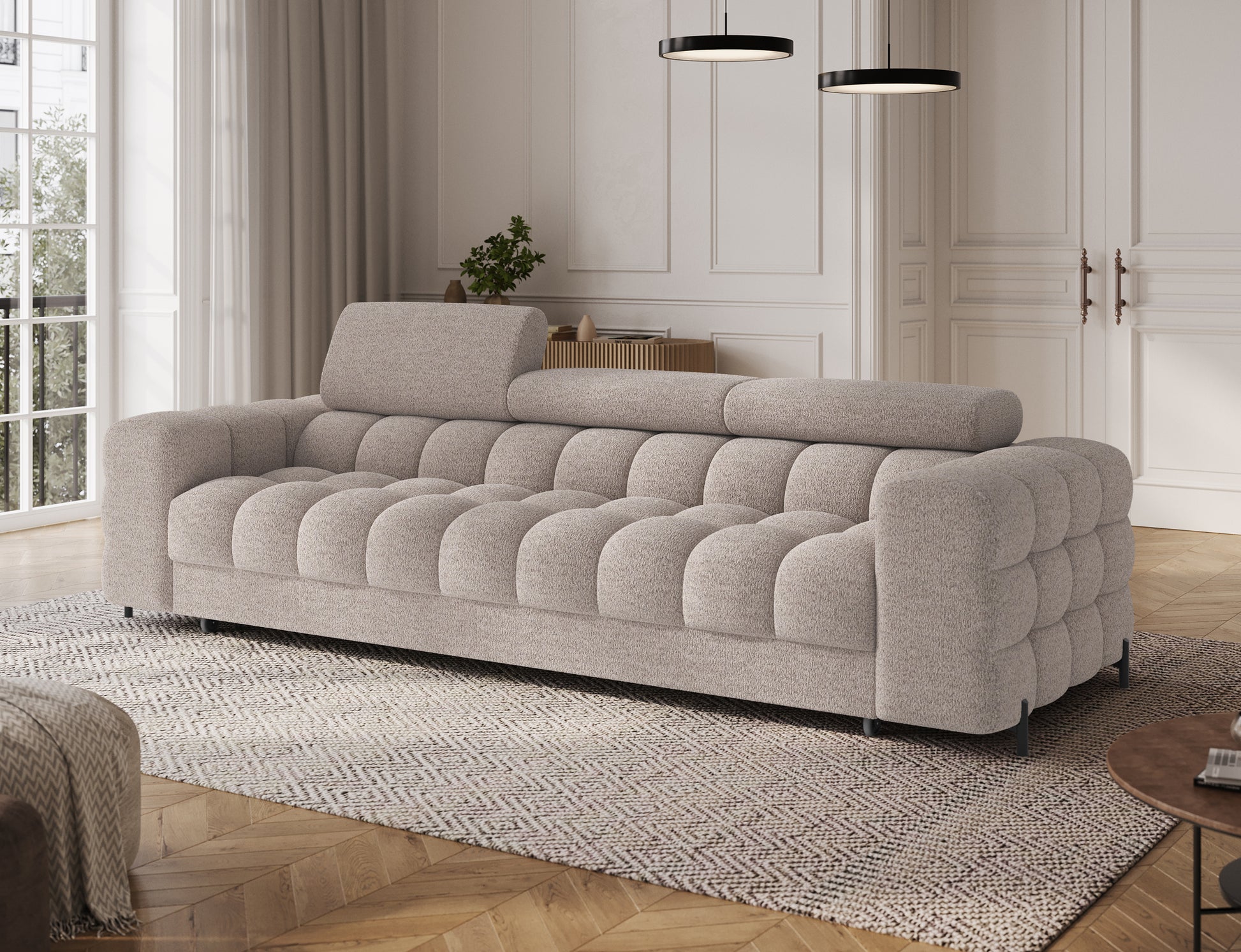 Sofa Festello Royal 18 jasnobeżowa z funkcją spania – widok skośny, nowoczesny design i regulowane zagłówki.