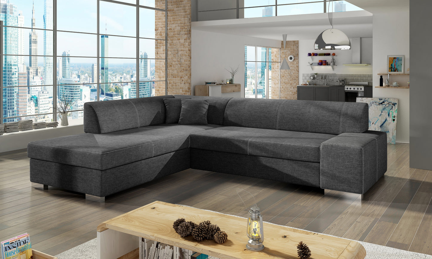 Ciemnoszara sofa narożna Porto wykonana z materiału Sawana 05 doskonale sprawdzi się w nowoczesnych i minimalistycznych wnętrzach, oferując wygodne siedziska oraz estetyczny wygląd dopasowany do różnych aranżacji