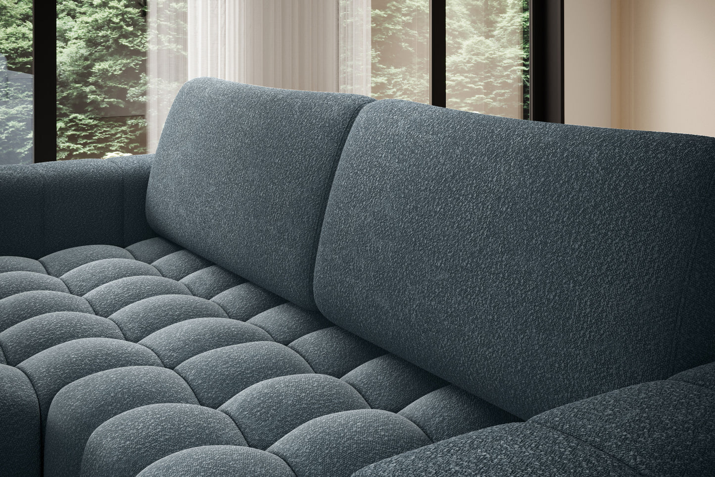 Zbliżenie na miękkie, pikowane siedzisko narożnika Bonett w kolorze niebieskim.