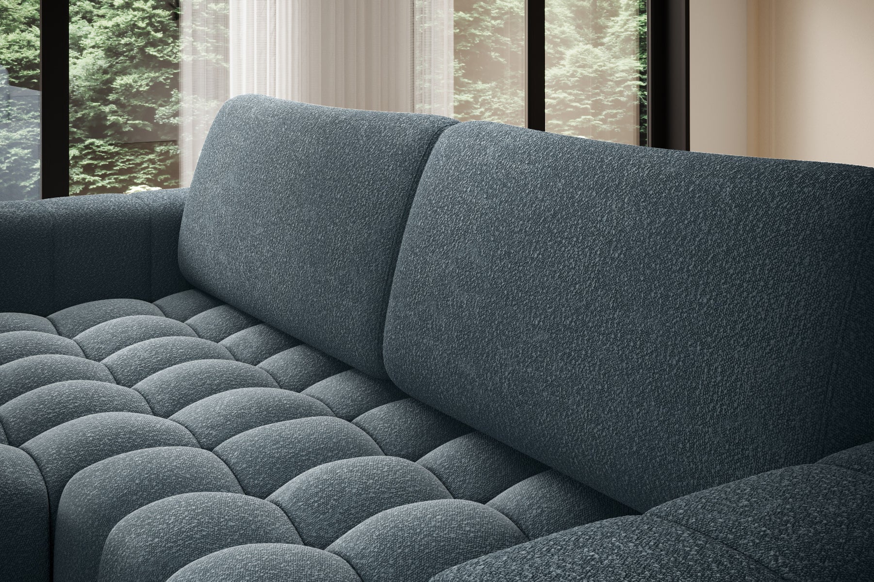 Zbliżenie na miękkie, pikowane siedzisko narożnika Bonett w kolorze niebieskim.