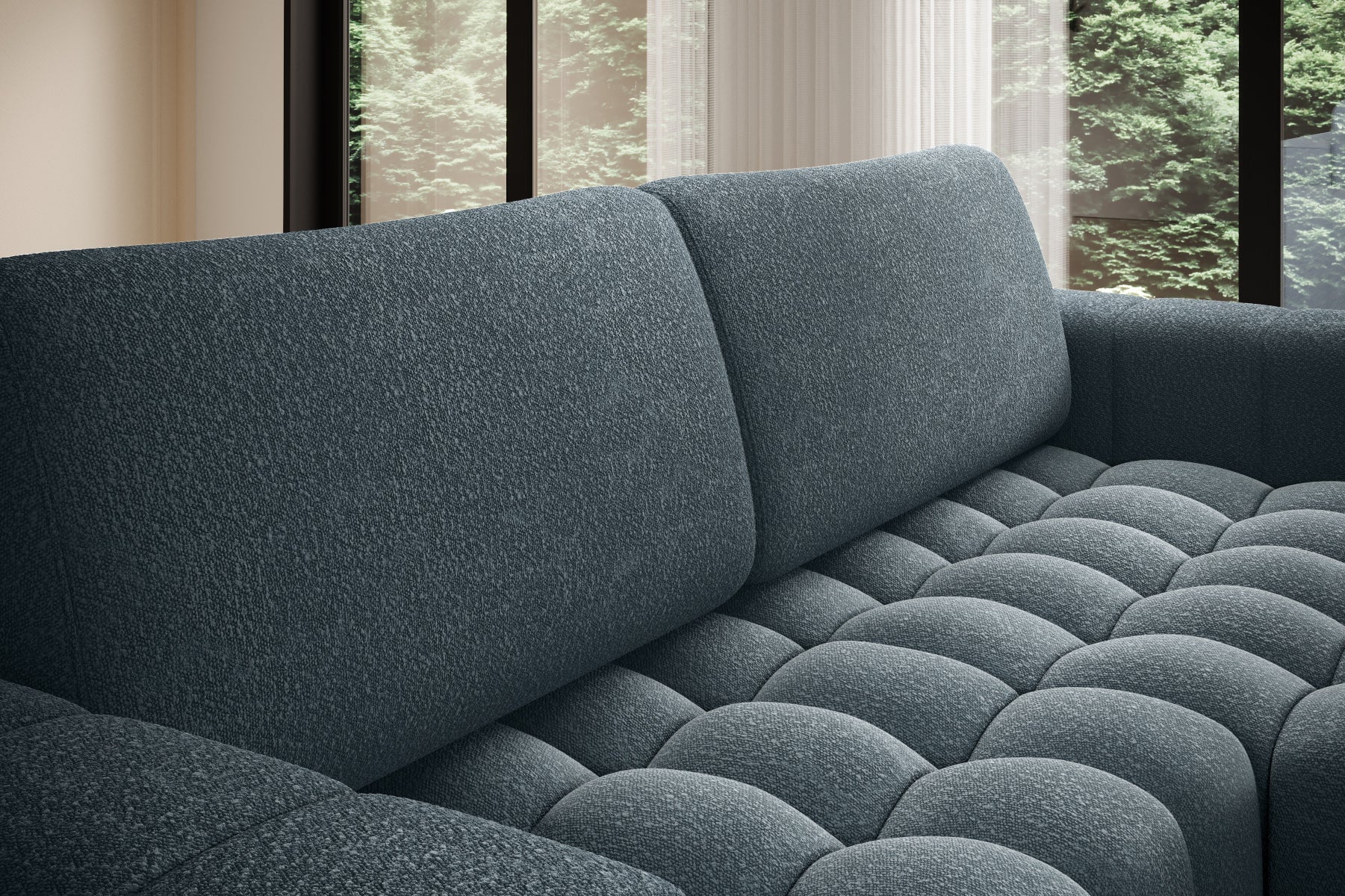 Zbliżenie na miękkie, pikowane siedzisko narożnika Bonett w kolorze niebieskim.