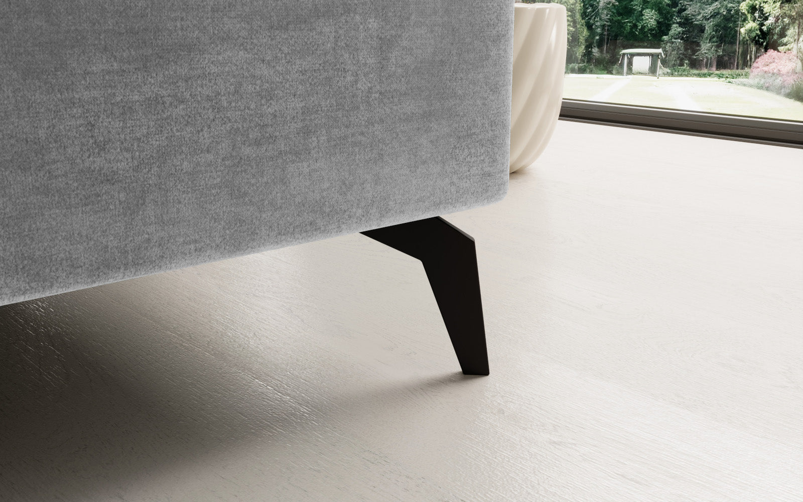 Jasnoszary narożnik Solange Monolith 84 prawostronny to designerski mebel do salonu, który dzięki pikowaniom i miękkim poduszkom tworzy przytulną, nowoczesną strefę wypoczynku.