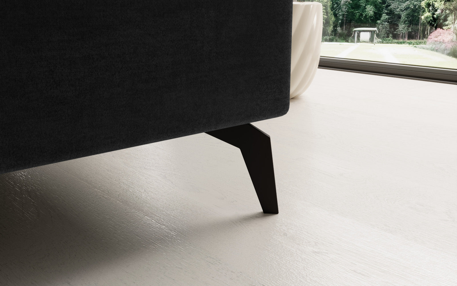 Ciemnoszary narożnik Solange Monolith 97 prawostronny to designerski mebel do salonu, który dzięki pikowaniom i miękkim poduszkom tworzy przytulną, nowoczesną strefę relaksu.