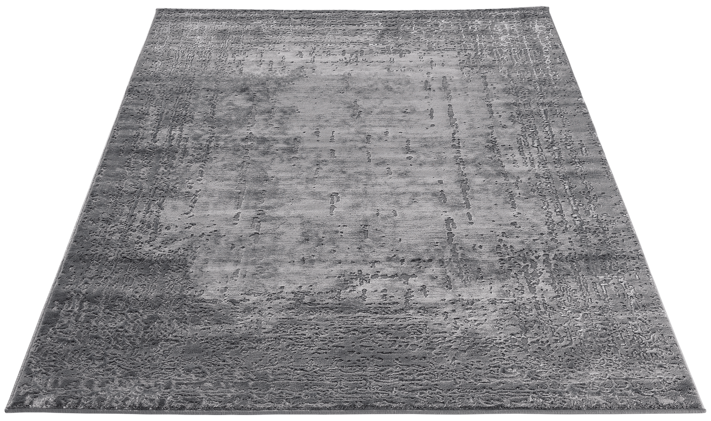 Dywan Codrila Grey 120x180 cm widziany z góry, prezentujący subtelny, strukturalny wzór inspirowany fakturą betonu.