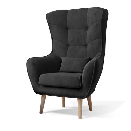 Fotel Arti w kolorze Monolith 97 ciemnoszary, nowoczesny fotel uszak z wysokim oparciem, poduszką i drewnianymi nogami.