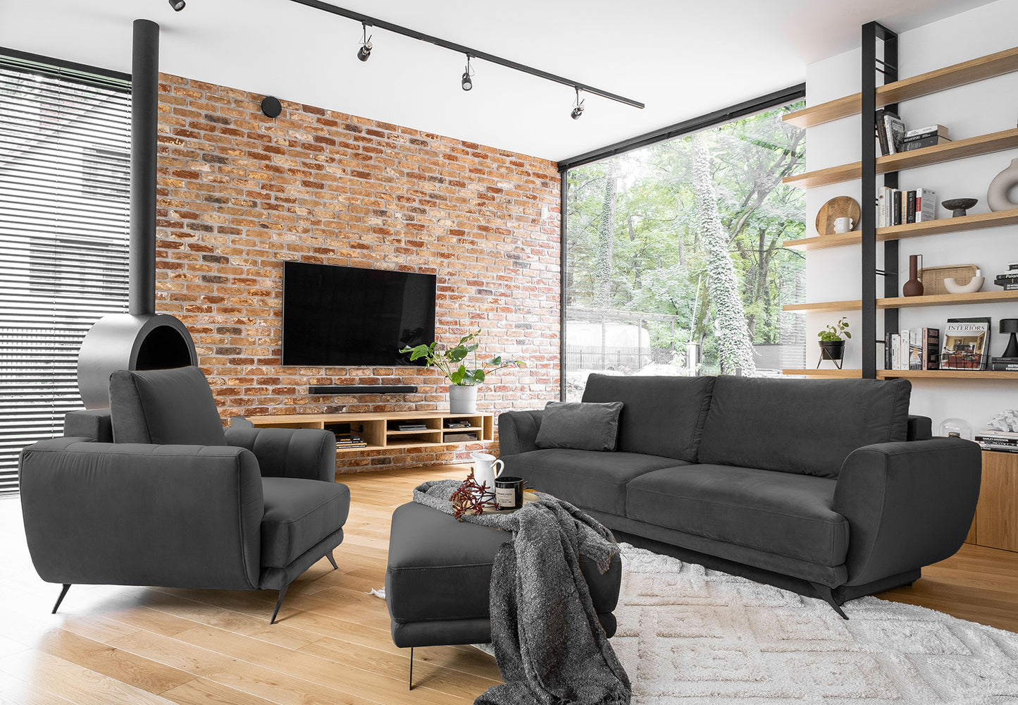 Zestaw Megis Nube w odcieniu ciemnej szarości tworzy wygodną przestrzeń do codziennego relaksu. Sofa, fotel oraz pufa zapewniają funkcjonalność i spójny wygląd.
