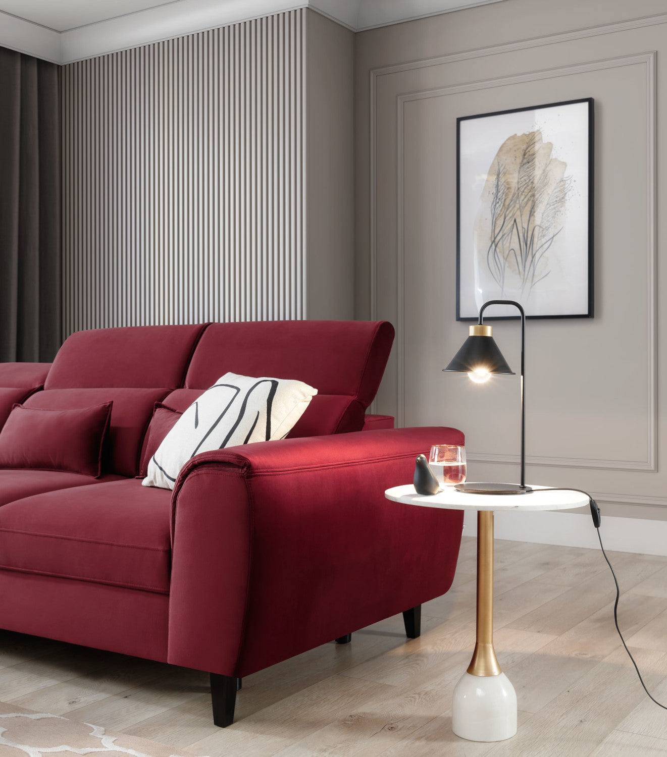 Lampa stołowa Detmer w kolorze czarnym ustawiona na marmurowym stoliku obok czerwonej sofy, pod abstrakcyjnym obrazem i przy dużym oknie w nowoczesnym salonie.