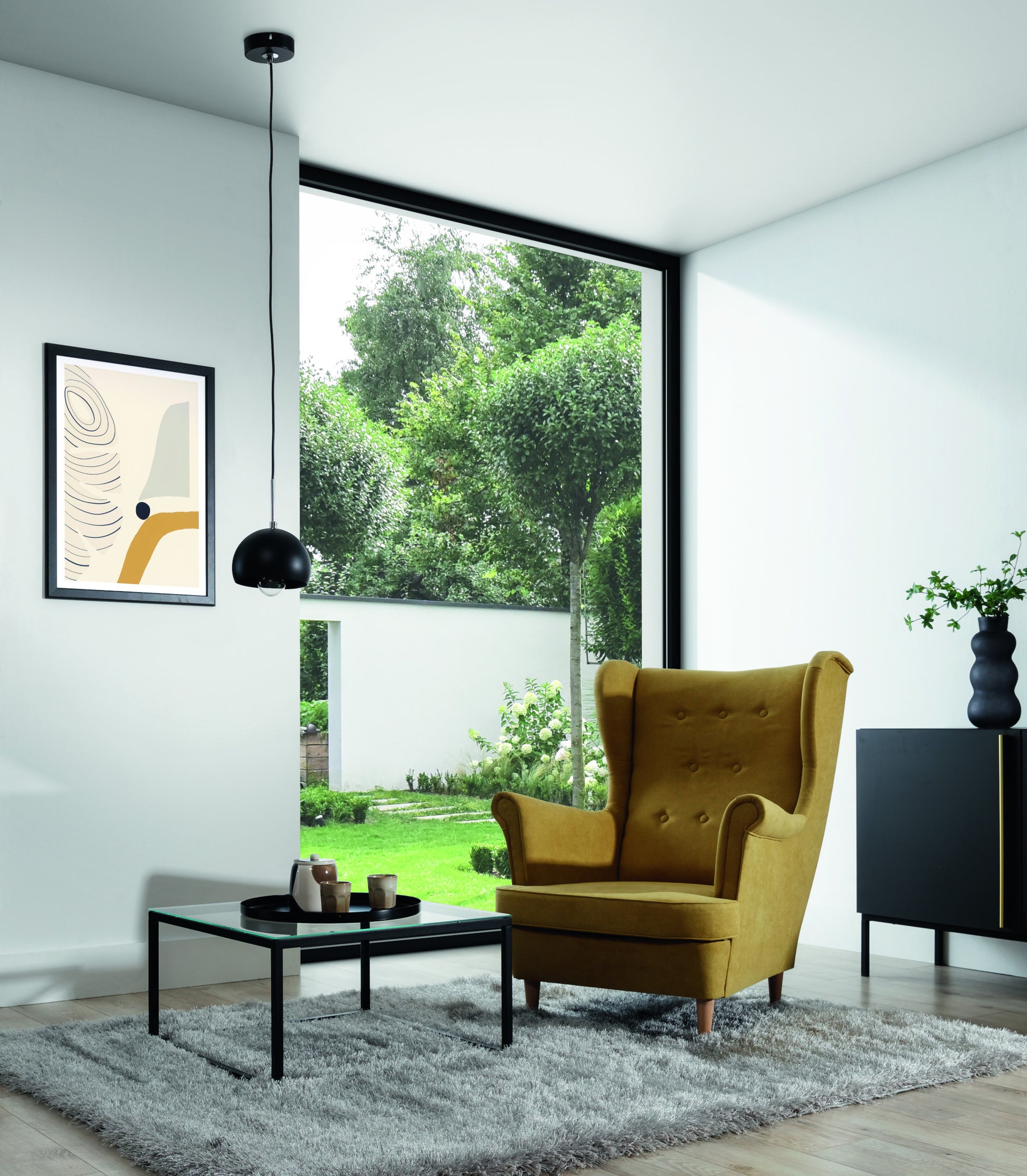 Lampa wisząca Canonus czarna 15x110 cm w aranżacji salonu – pojedynczy zwis nad strefą wypoczynku