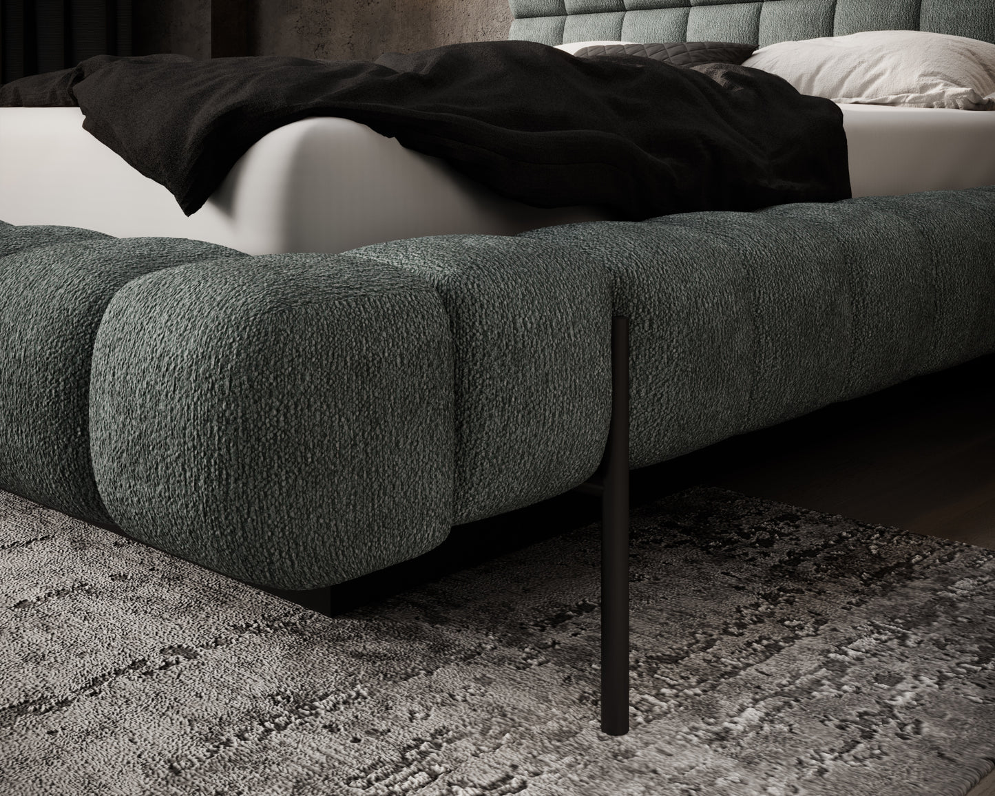 Narożnik tapicerowanego łóżka Magentta Touch 100 zielony z widoczną metalową nogą i detalem materaca na ciemnym tle.