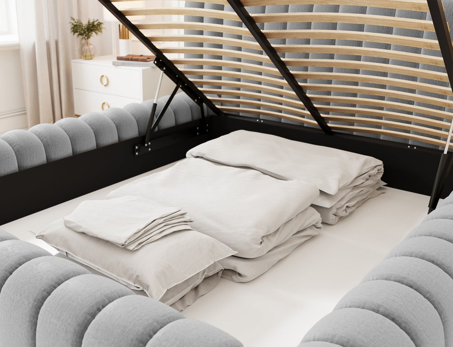 Pojemnik na pościel łóżka Carilla Monolith 85 szary z otwieranym stelażem i starannie ułożonym kompletem pościeli.