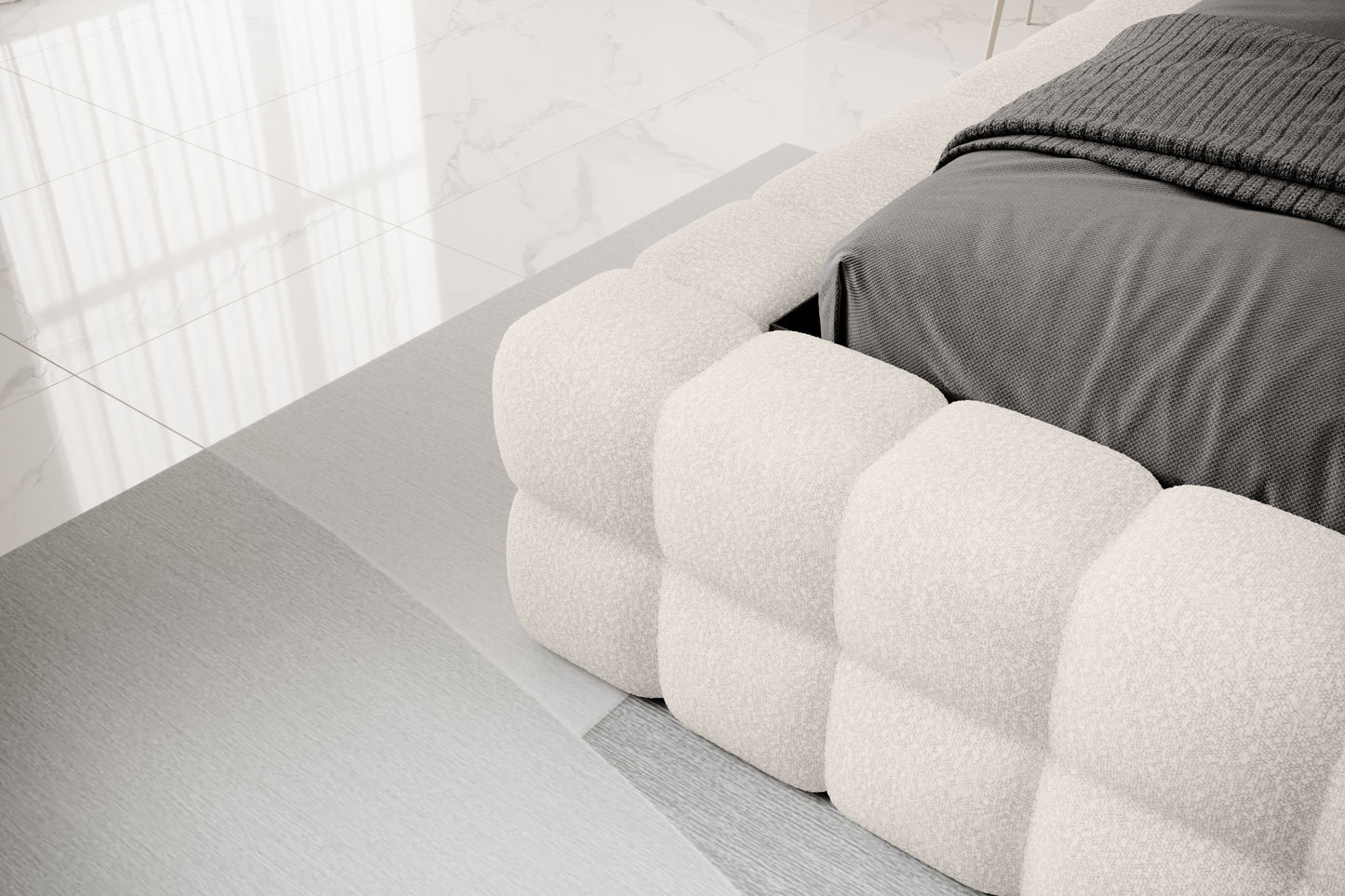 Detal narożnika łóżka Dizzle 180x200 cm w tkaninie Jaffray 01 biały, ukazujący miękkie, tapicerowane wykończenie w stylowym, minimalistycznym wnętrzu.