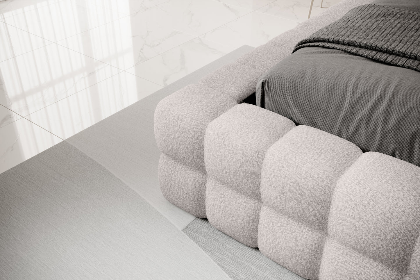 Detal narożnika łóżka Dizzle 160x200 cm w tkaninie Jaffray 03 szary, ukazujący miękkie, tapicerowane wykończenie w stylowym, minimalistycznym wnętrzu.