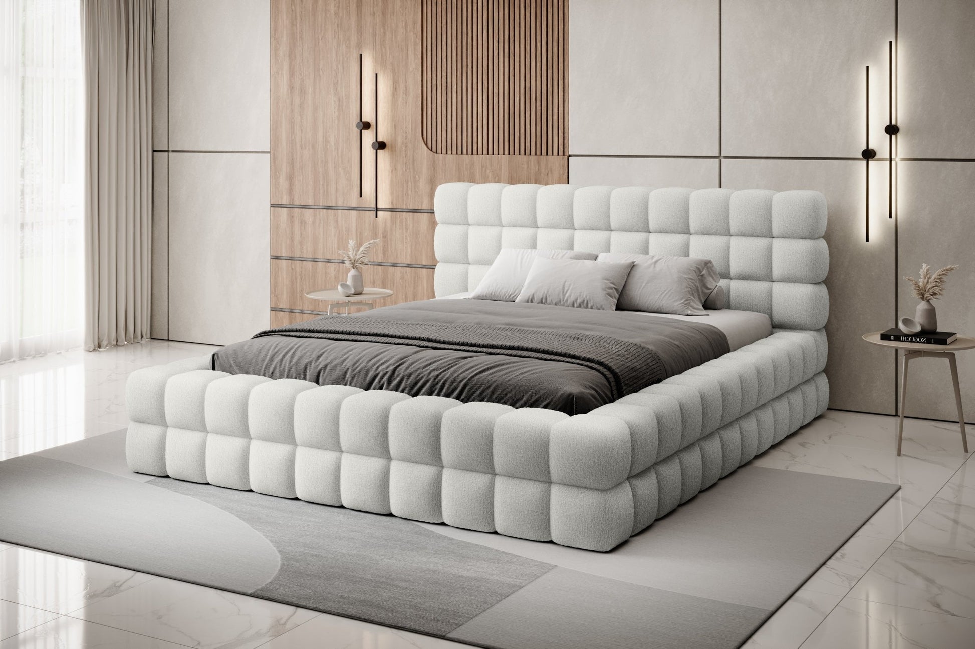 Łóżko Dizzle 180x200 cm w kolorze Royal 01 biały ustawione w eleganckiej, nowoczesnej sypialni z drewnianymi akcentami i designerskim oświetleniem.