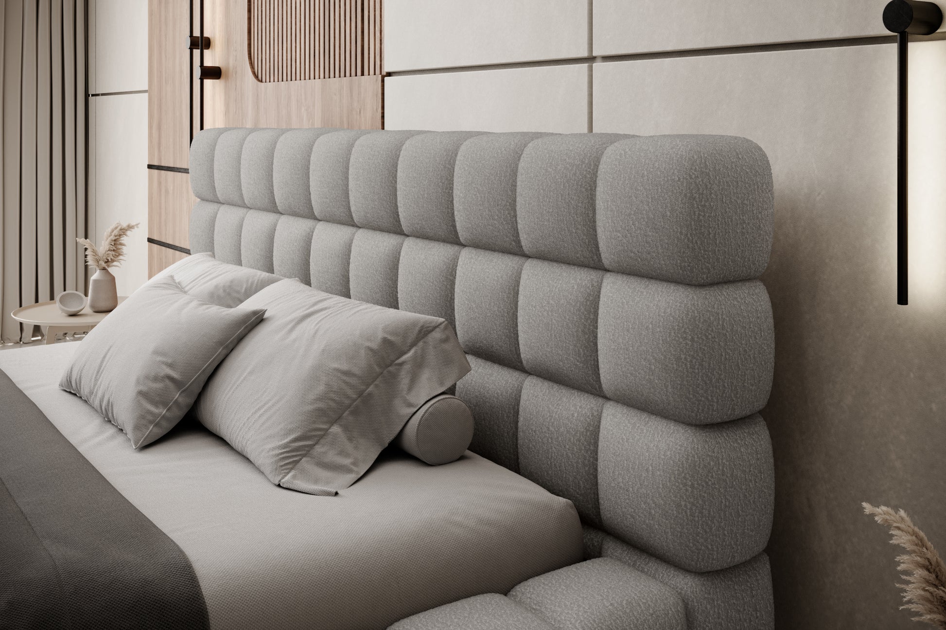 Zbliżenie na pikowany zagłówek łóżka Dizzle 140x200 cm w tkaninie Royal 04 szary, z eleganckimi poduszkami w nowoczesnej sypialni.