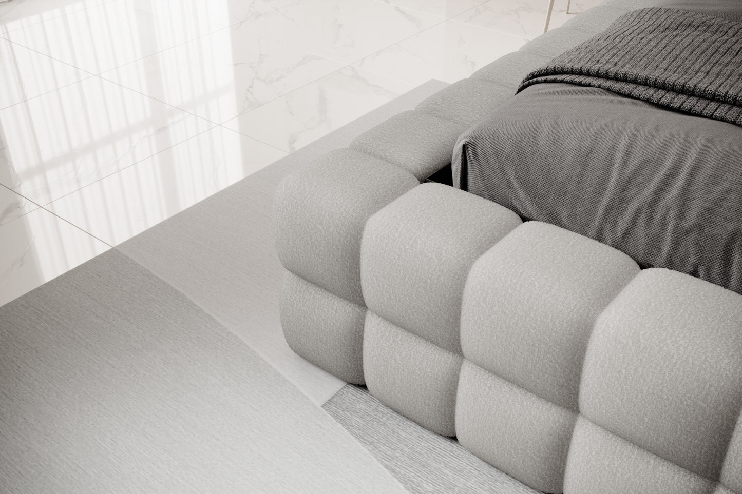 Detal narożnika łóżka Dizzle 140x200 cm w tkaninie Royal 04 szary, ukazujący miękkie, tapicerowane wykończenie w stylowym, minimalistycznym wnętrzu.