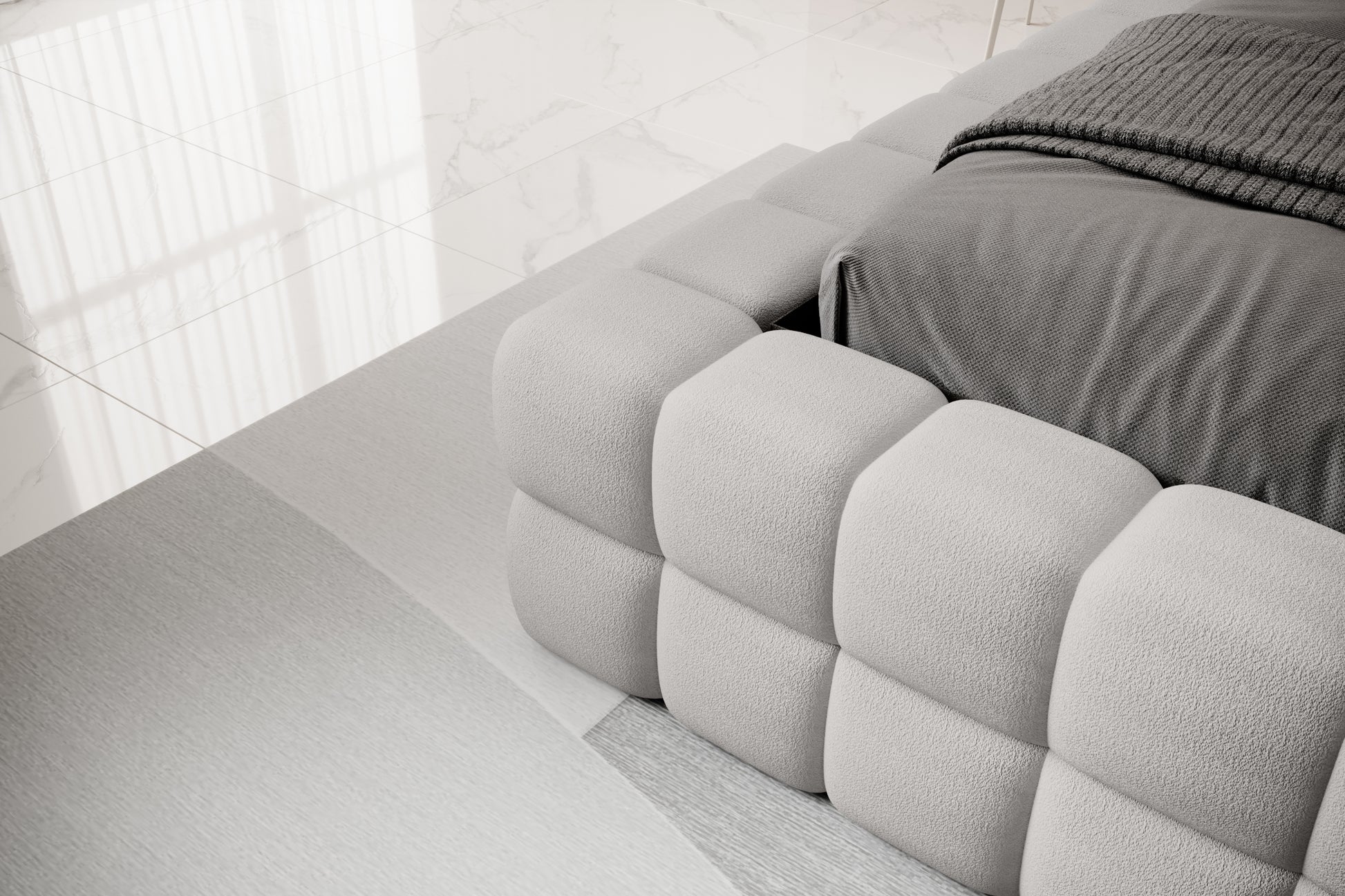 Detal narożnika łóżka Dizzle 180x200 cm w tkaninie Touch 03 jasnoszary, ukazujący miękkie, tapicerowane wykończenie w stylowym, minimalistycznym wnętrzu.