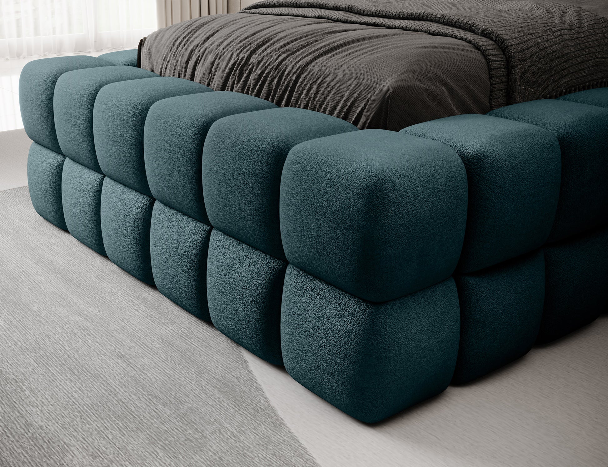 Detal łóżka Dizzle 90 Amore 38 turkusowy – narożnik tapicerowanej ramy z charakterystycznym, miękkim pikowaniem.